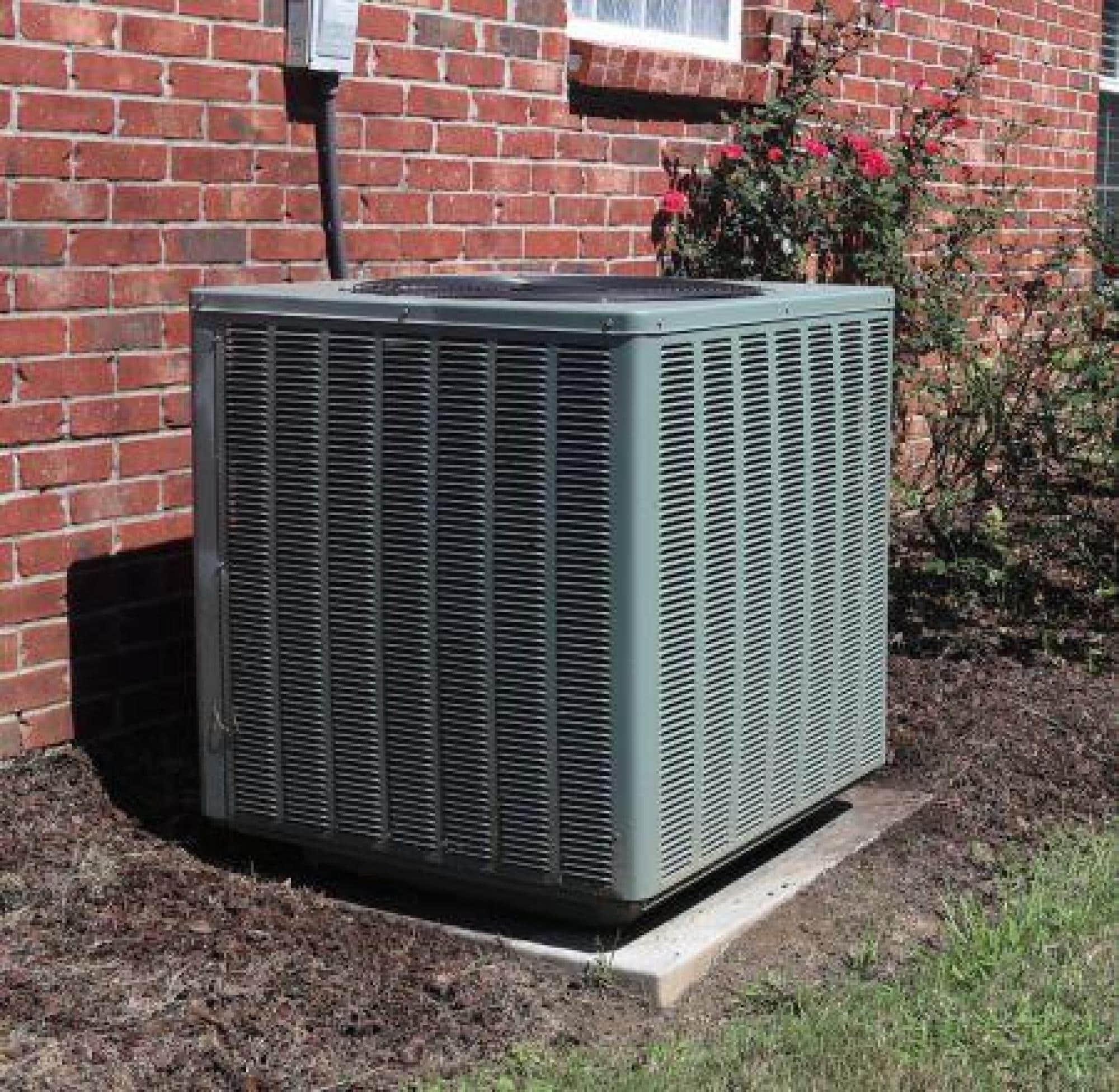 Outdoor HVAC Unit Next To A Brick Wall
