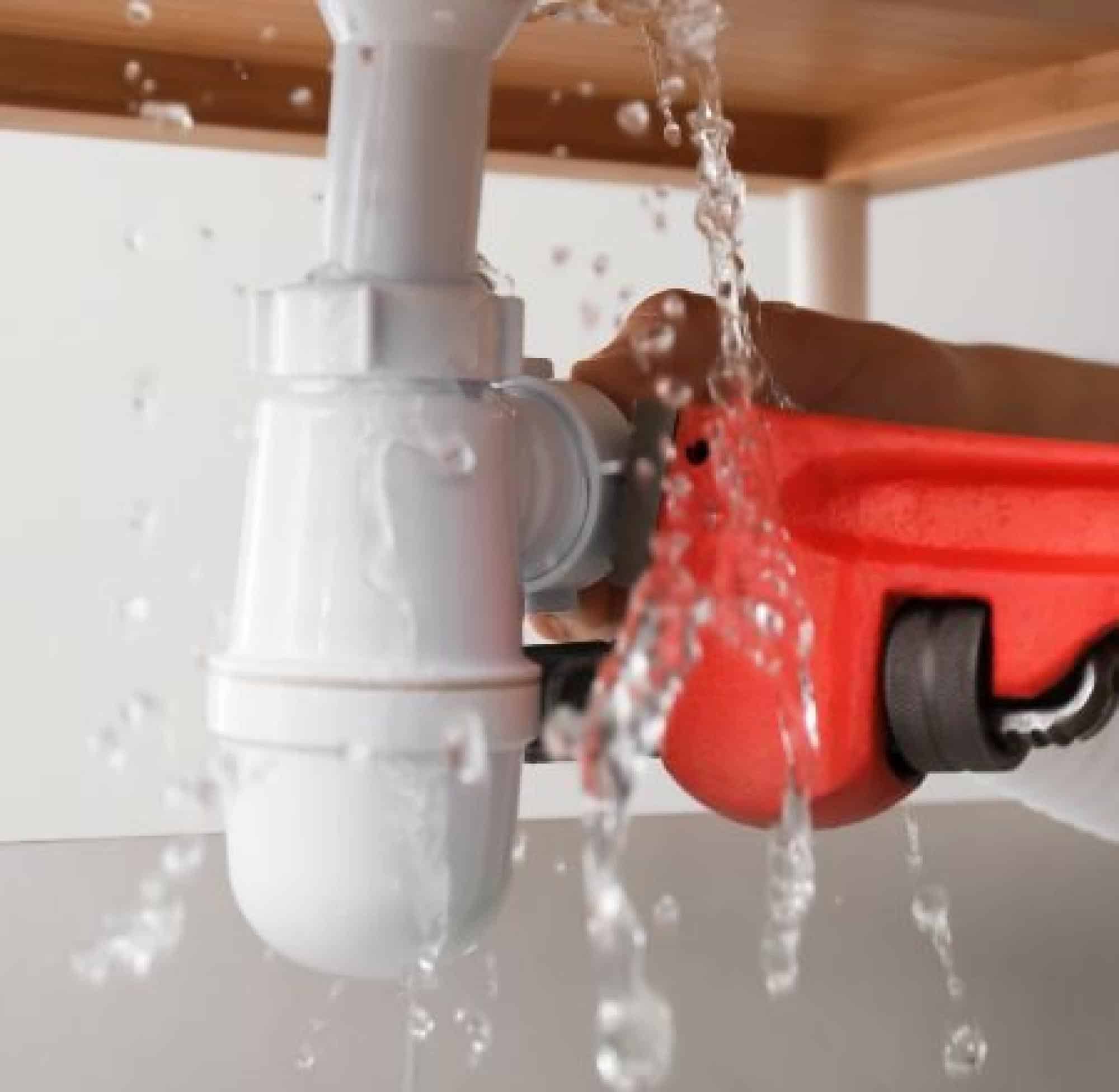  Plumber Fixing A Leaking Pipe