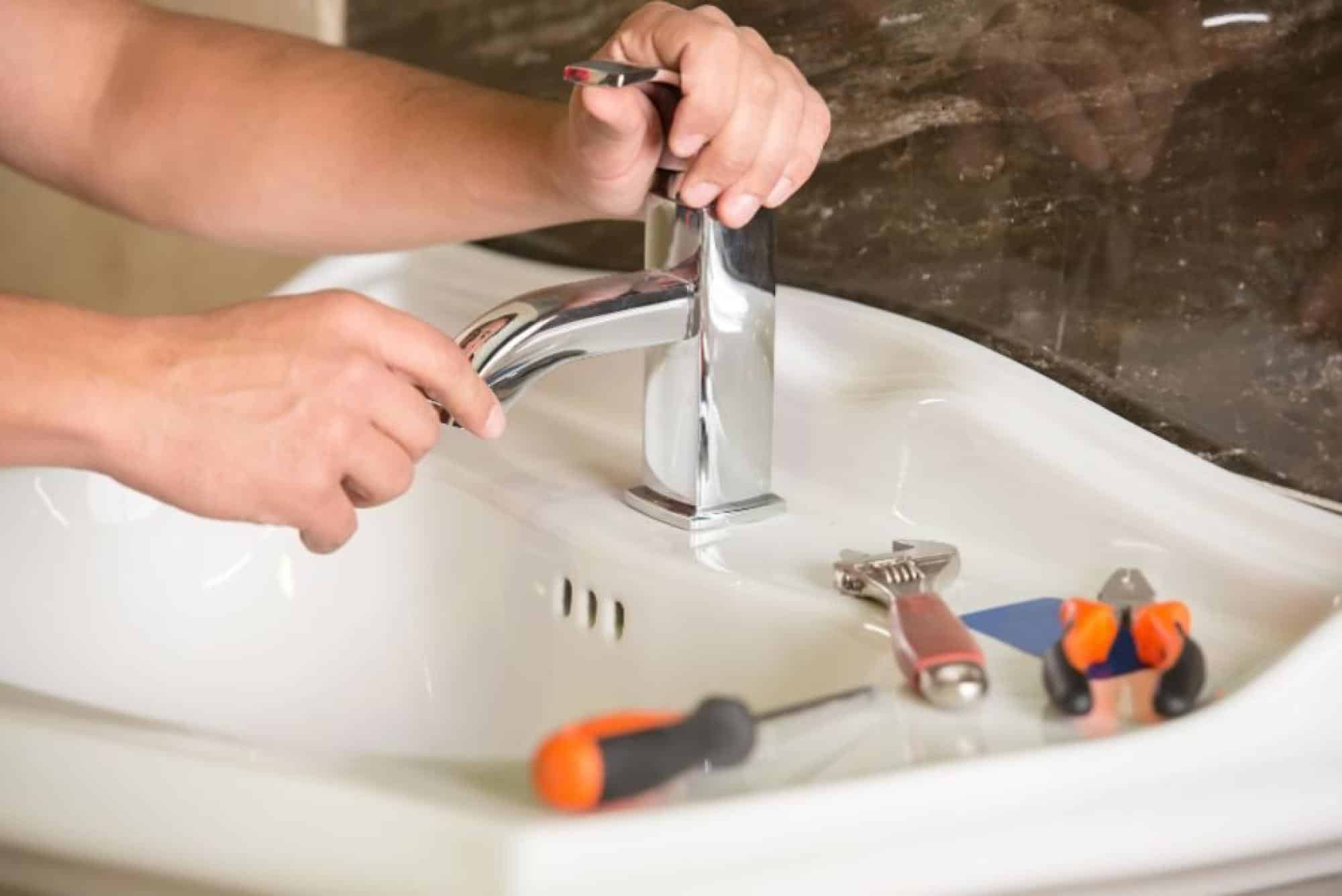 Sink Faucet Being Fixed With Tools