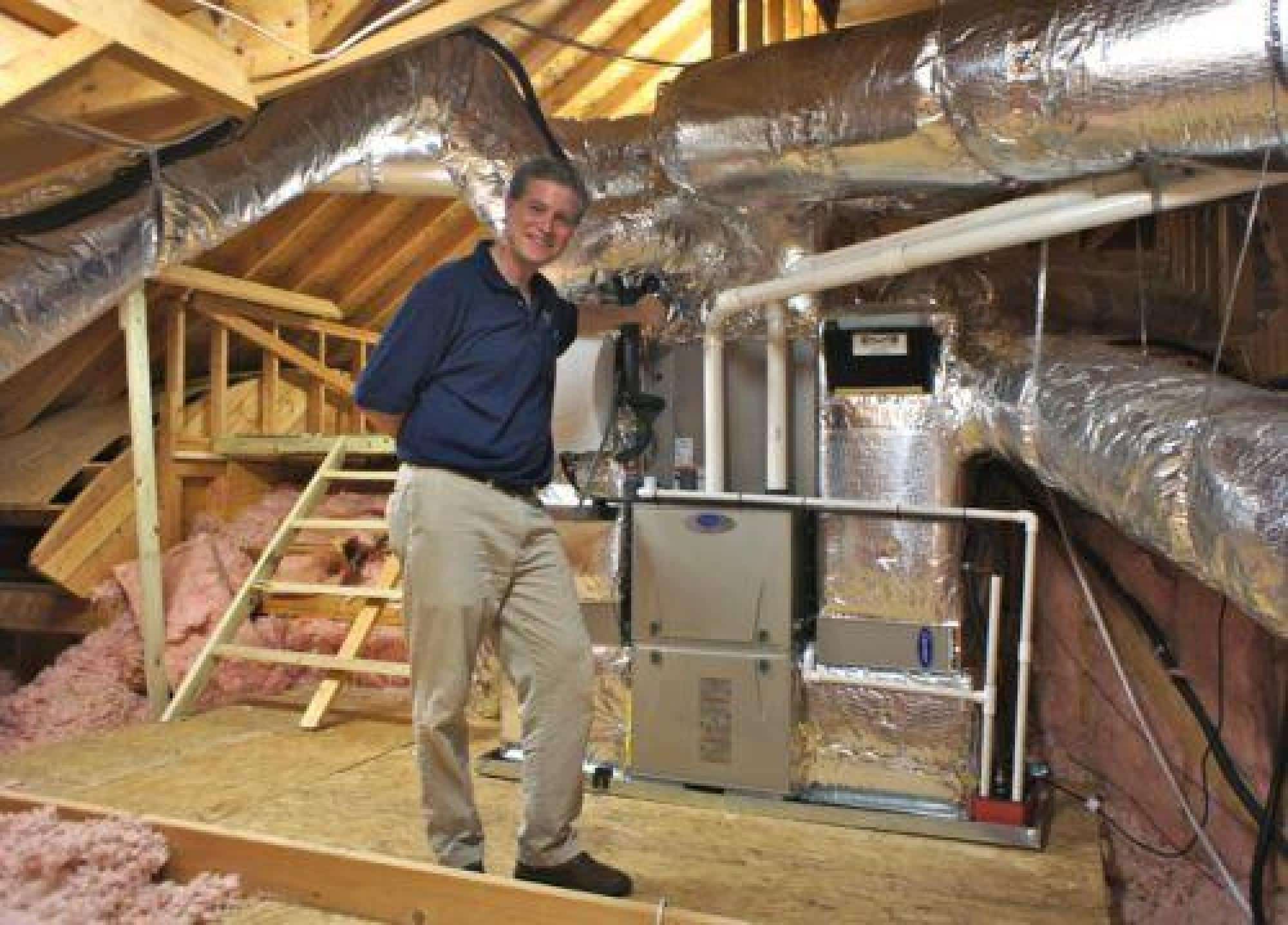 Technician Standing Near A Furnace System