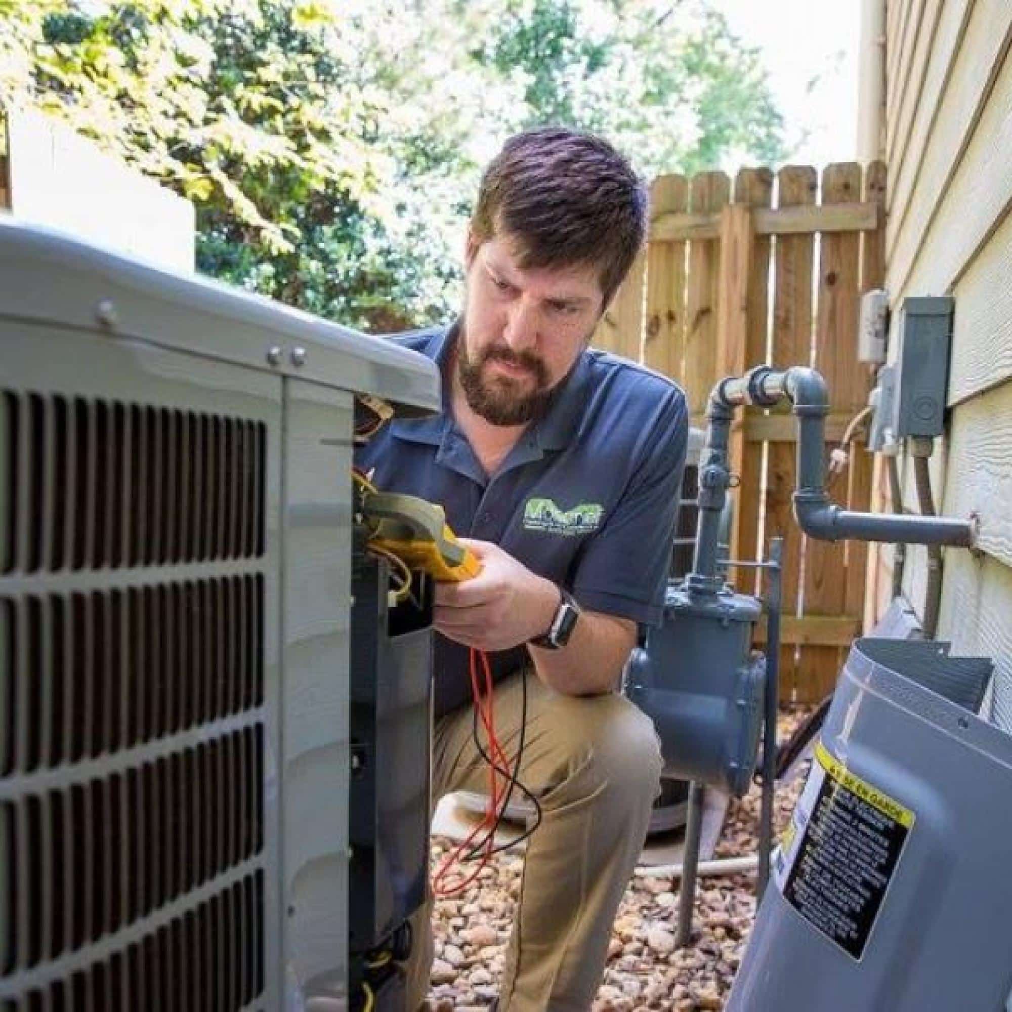 Technician Testing Air Conditioning Unit