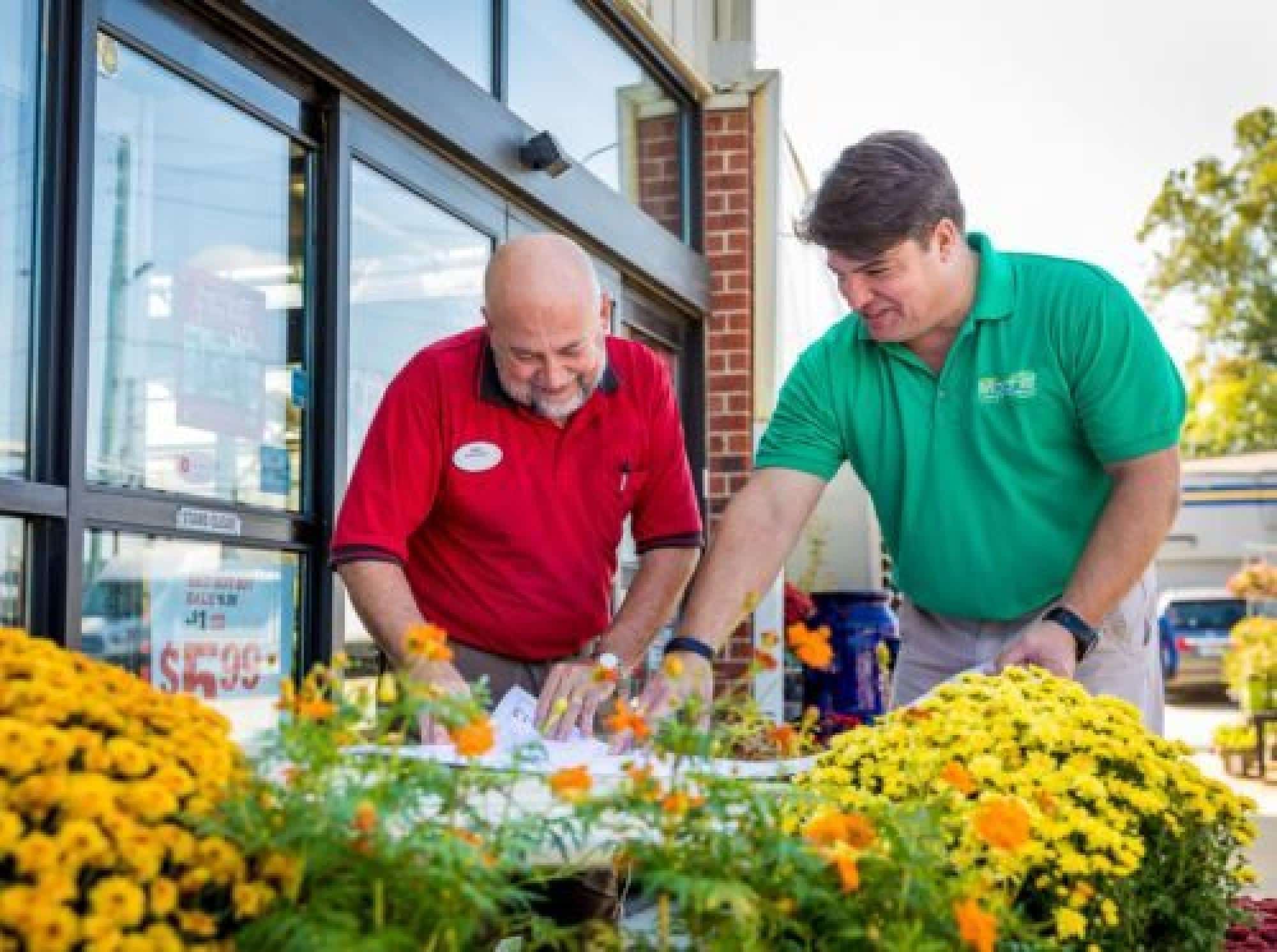 Two Men Reviewing Plans Outside A Building