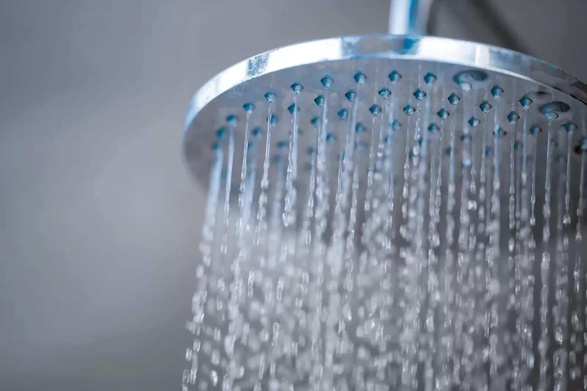 water streaming from rain shower head in bathroom
