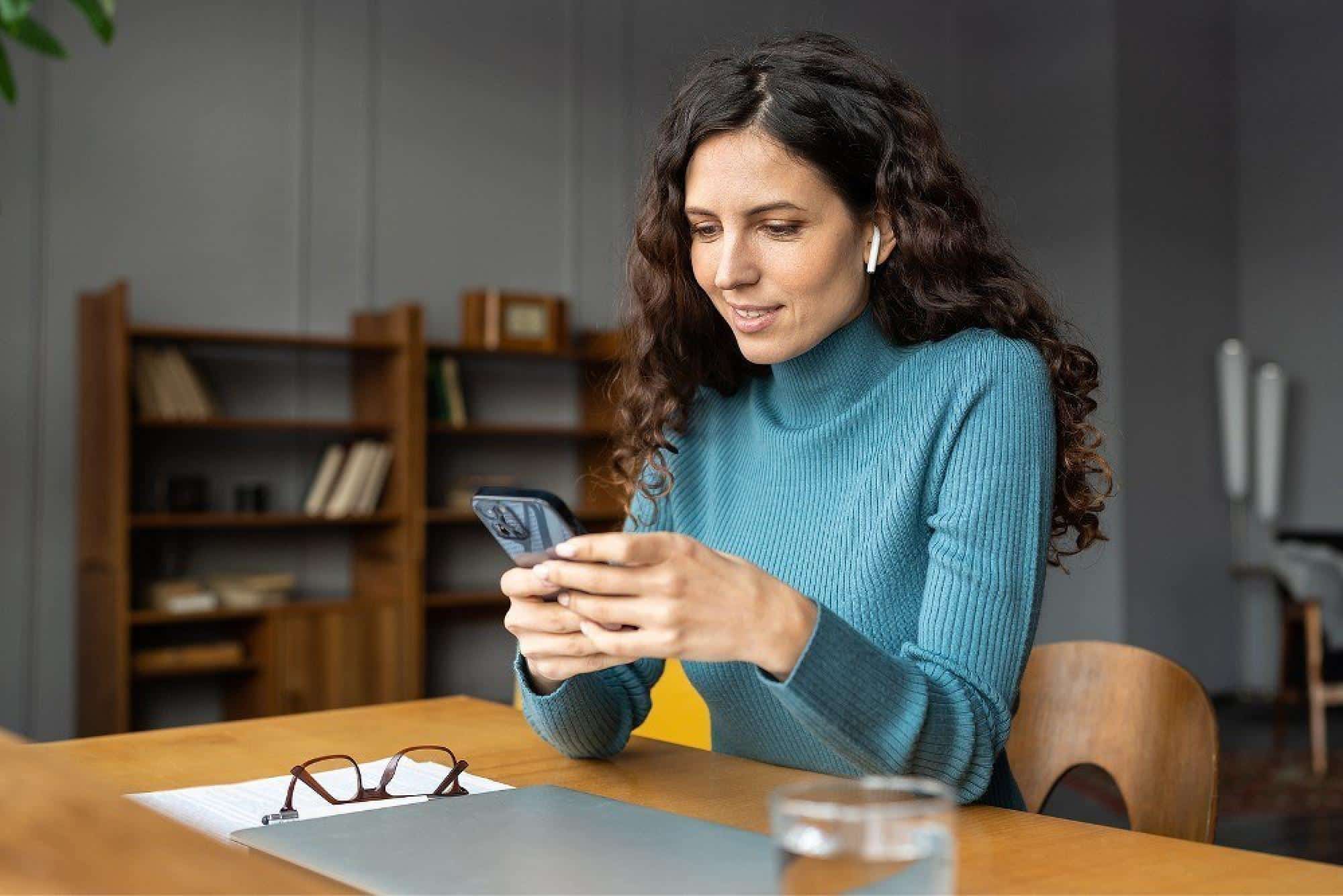 Woman Checking Phone For HVAC Service Appointment Notifications